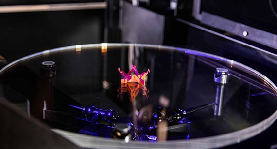 orange 3D part laser being scanned in Brazil Metal Parts' metrology lab