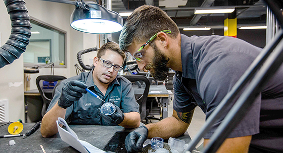 secodary operations technicians adding clear coat polish on 3D printed parts