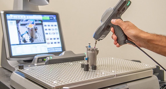 3d printing technician measures direct metal laser sintering part with CT scanning
