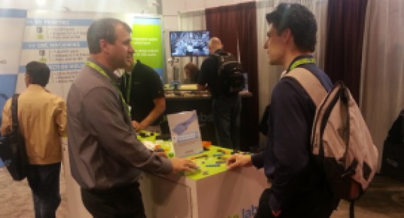 Brazil Metal Parts employee talks with trade show guest